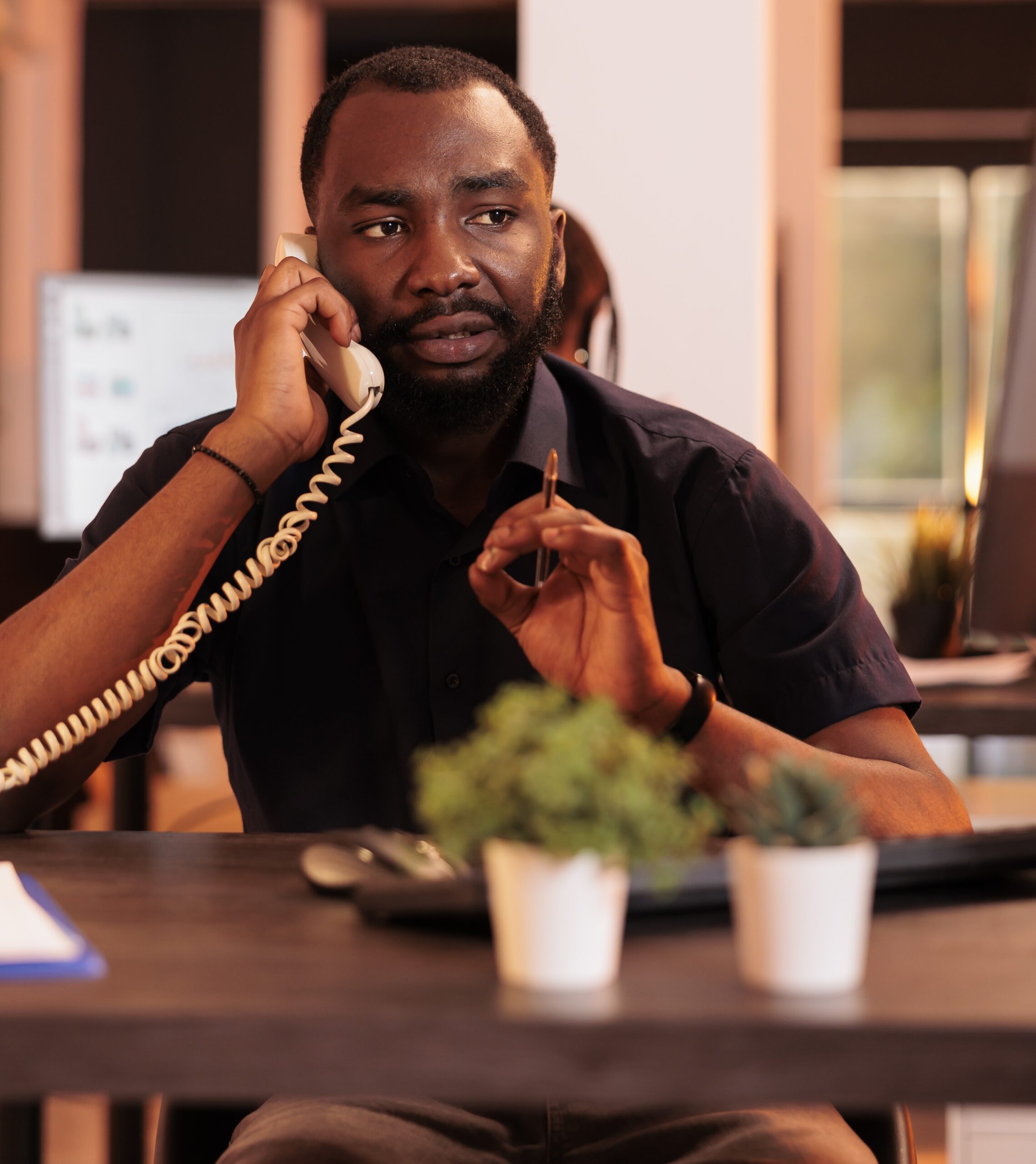 Male freelancer talking to people on landline phone